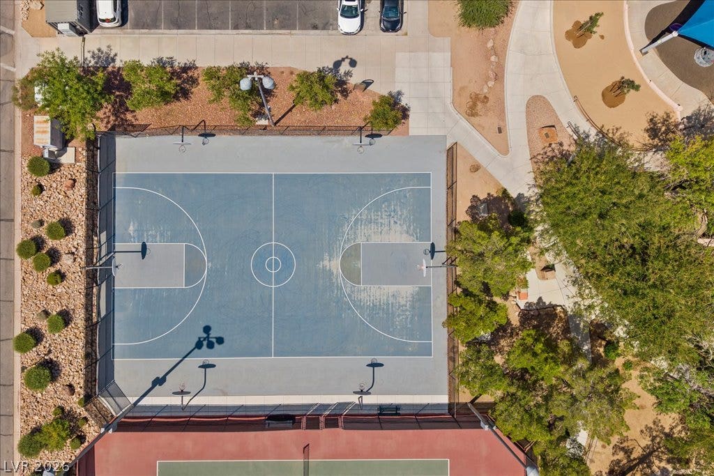 2000 Silverton Drive, Henderson, NV 89074 An aerial view captures the vibrant blue basketball court alongside a red tennis court.