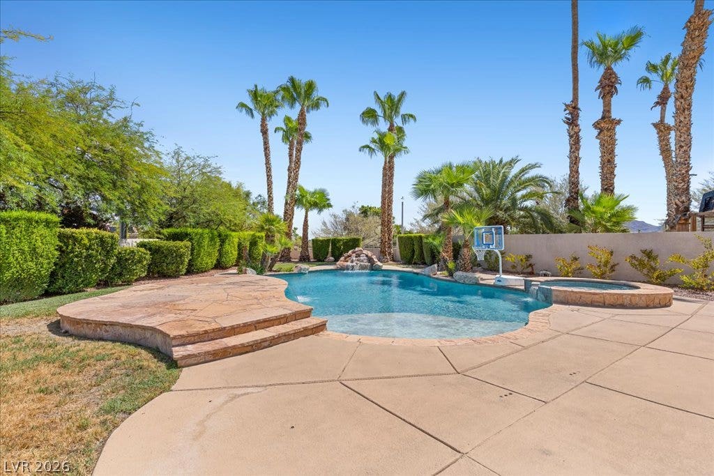 2000 Silverton Drive, Henderson, NV 89074 A desert oasis awaits, with a curvaceous pool, integrated spa, and an inviting stone patio.