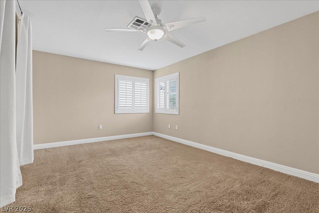2000 Silverton Drive, Henderson, NV 89074 Well-lit and tranquil, this bedroom features inviting carpeting and adjustable window shutters for comfort.