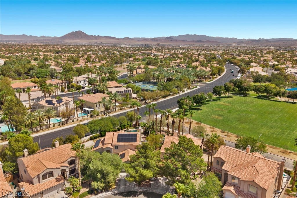 2000 Silverton Drive, Henderson, NV 89074 An aerial panorama reveals a vibrant community with lush landscaping and distant mountains under a clear sky.