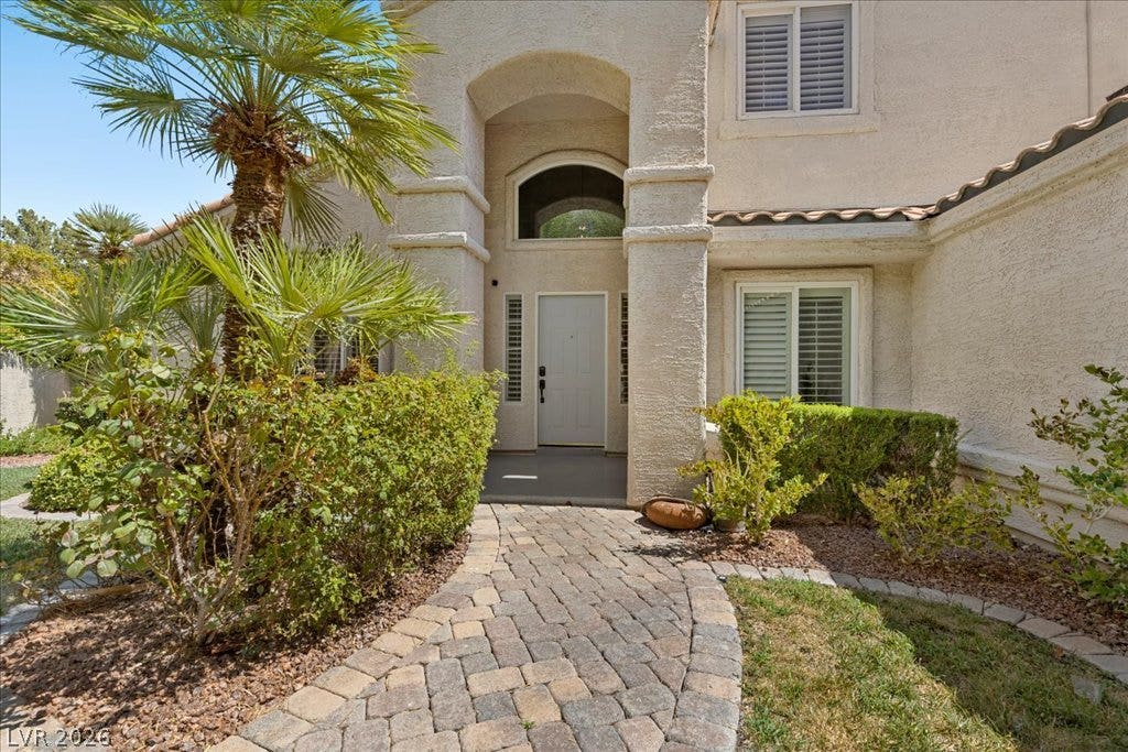 2000 Silverton Drive, Henderson, NV 89074 A welcoming paver walkway leads to the arched entry of this charming stucco residence.