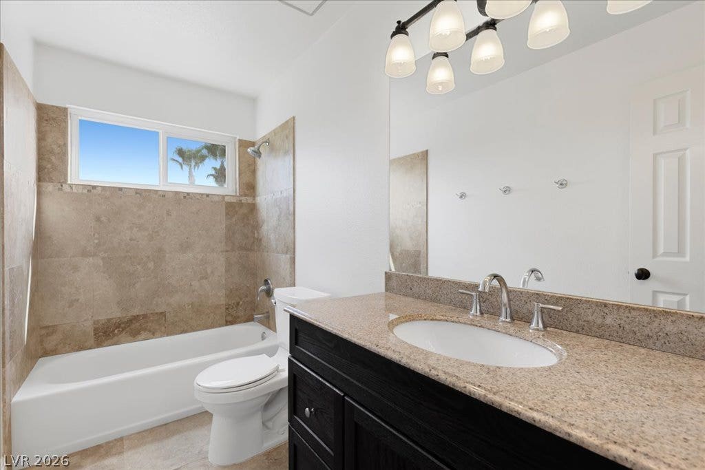 2000 Silverton Drive, Henderson, NV 89074 A well-appointed bathroom features a single vanity with granite counters and an elegant overhead light fixture.