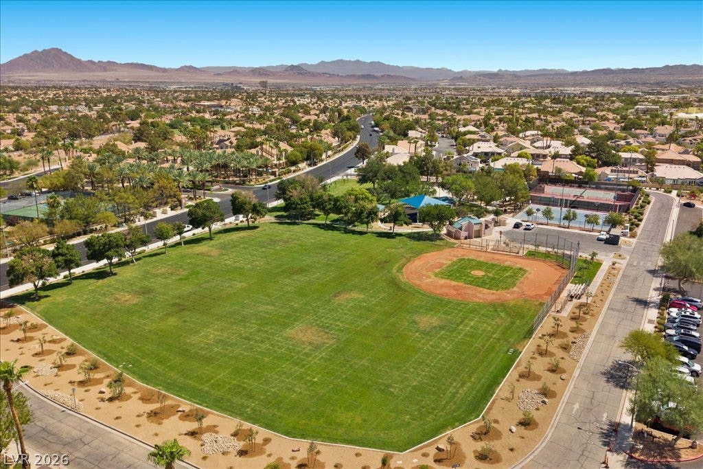 2000 Silverton Drive, Henderson, NV 89074 An aerial perspective reveals a vibrant community with recreational amenities nestled against a scenic mountain backdrop.