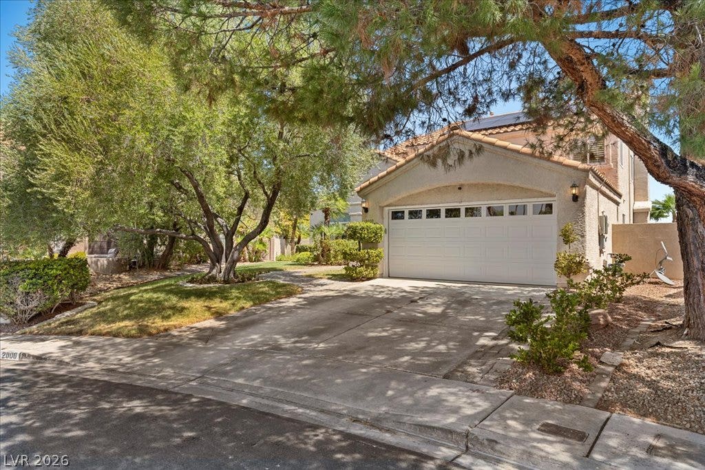 2000 Silverton Drive, Henderson, NV 89074 A well-maintained stucco home with an attached garage and mature landscaping offers inviting curb appeal.