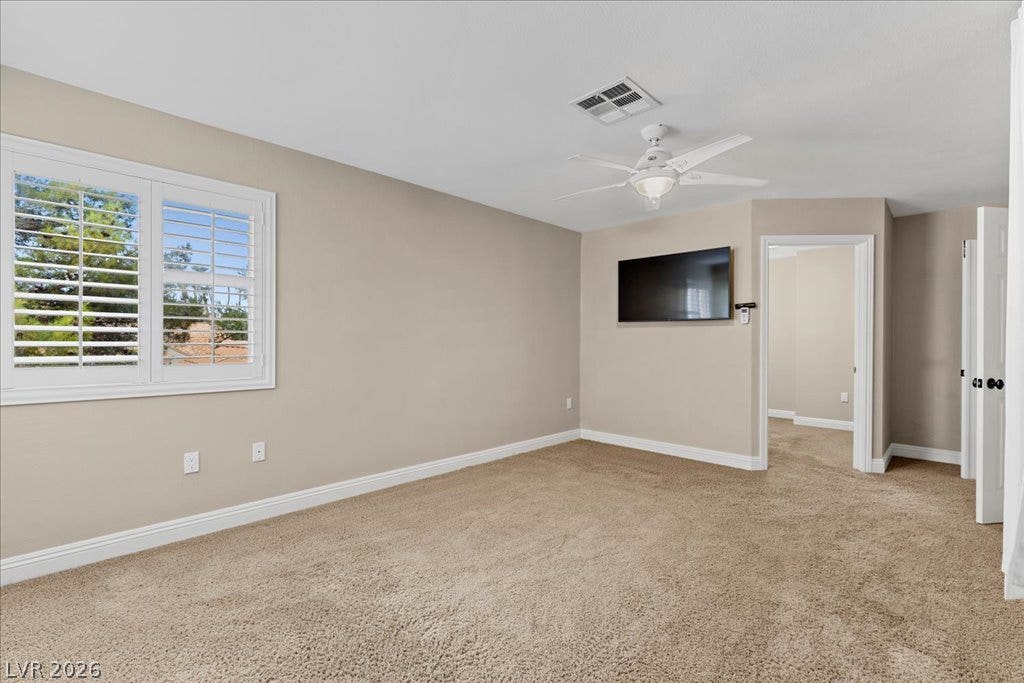 2000 Silverton Drive, Henderson, NV 89074 Well-lit room features soft carpet, a ceiling fan, and window shutters for privacy.