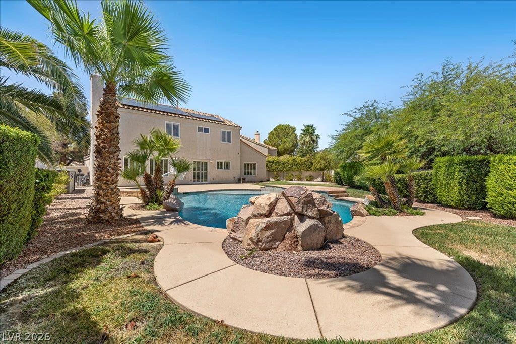 2000 Silverton Drive, Henderson, NV 89074 A private backyard oasis features a shimmering pool with a rock waterfall feature and generous patio space.