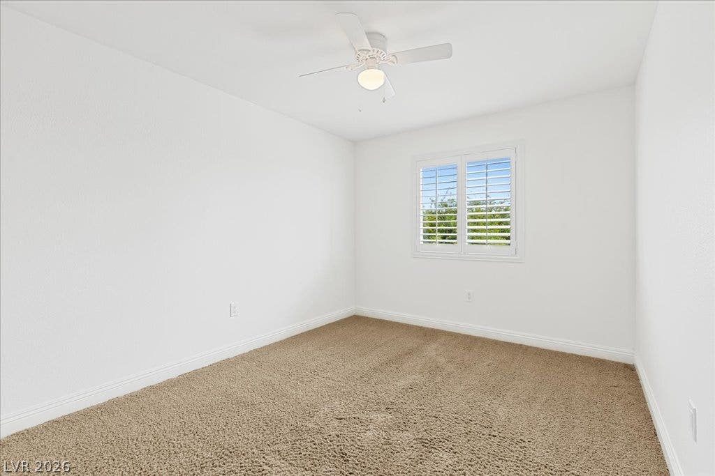2000 Silverton Drive, Henderson, NV 89074 A well-lit bedroom features plush carpeting and a window with plantation shutters.