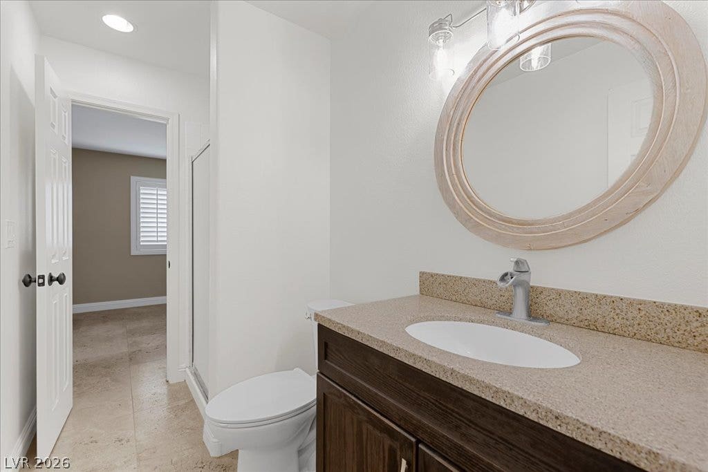 2000 Silverton Drive, Henderson, NV 89074 A well-appointed bathroom features a single vanity with granite counters and a shower next to a separate water closet.