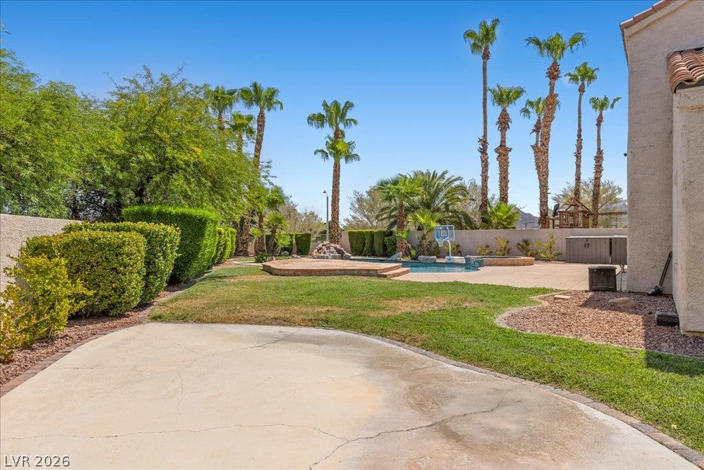 2000 Silverton Drive, Henderson, NV 89074 A spacious backyard oasis awaits with a refreshing pool and ample concrete patio space, perfect for outdoor enjoyment.