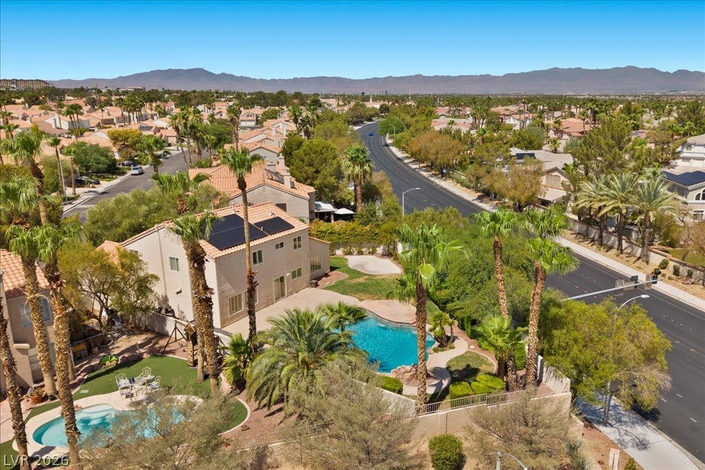 2000 Silverton Drive, Henderson, NV 89074 An aerial perspective reveals a private pool oasis nestled within a vibrant, palm-lined neighborhood.