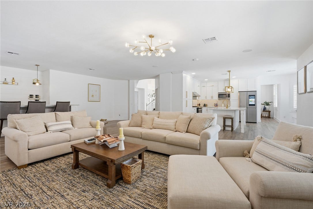 9615 Sedona Hills Court, Las Vegas, NV 89147 An inviting open-concept living space integrates a stylish kitchen and dining area for seamless entertaining.