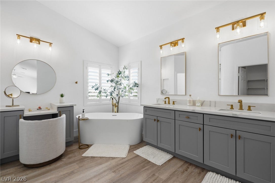 9615 Sedona Hills Court, Las Vegas, NV 89147 Indulge in a tranquil retreat featuring a spacious freestanding tub and stylish double vanities.