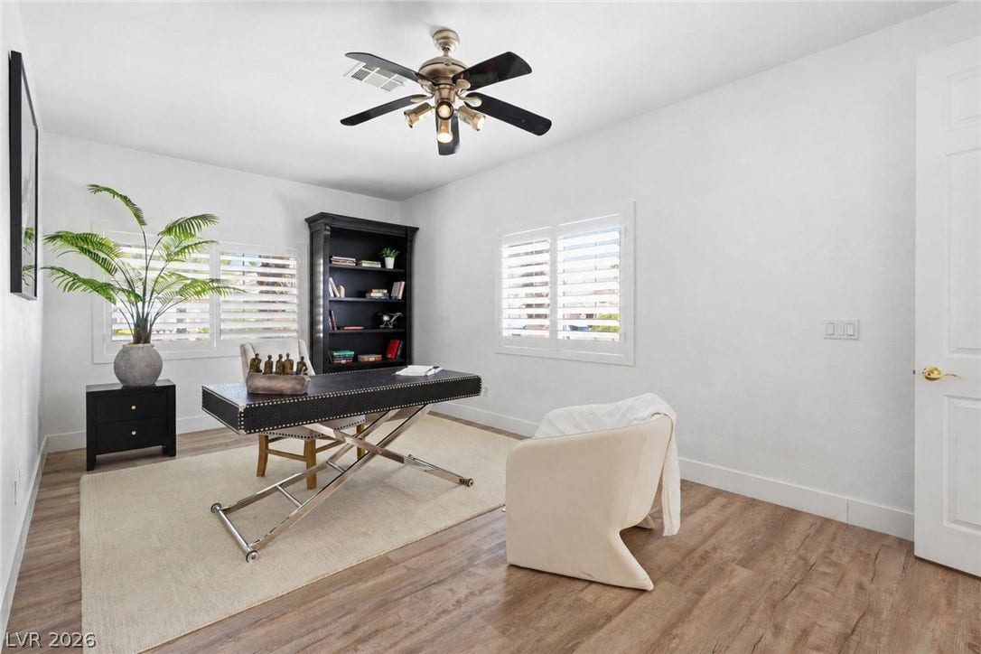 9615 Sedona Hills Court, Las Vegas, NV 89147 A well-lit study provides a productive environment with rich wood flooring and a refreshing ceiling fan.