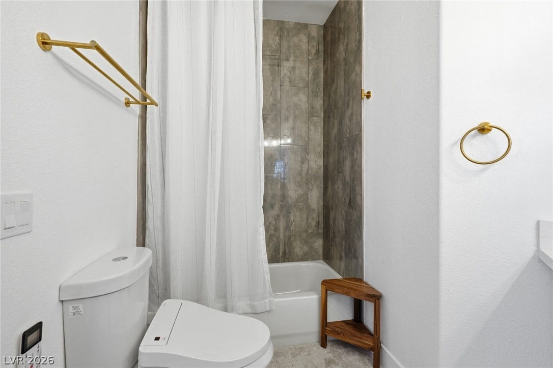 9615 Sedona Hills Court, Las Vegas, NV 89147 A well-appointed bathroom features a shower-tub combination with sleek tile surround and modern fixtures.