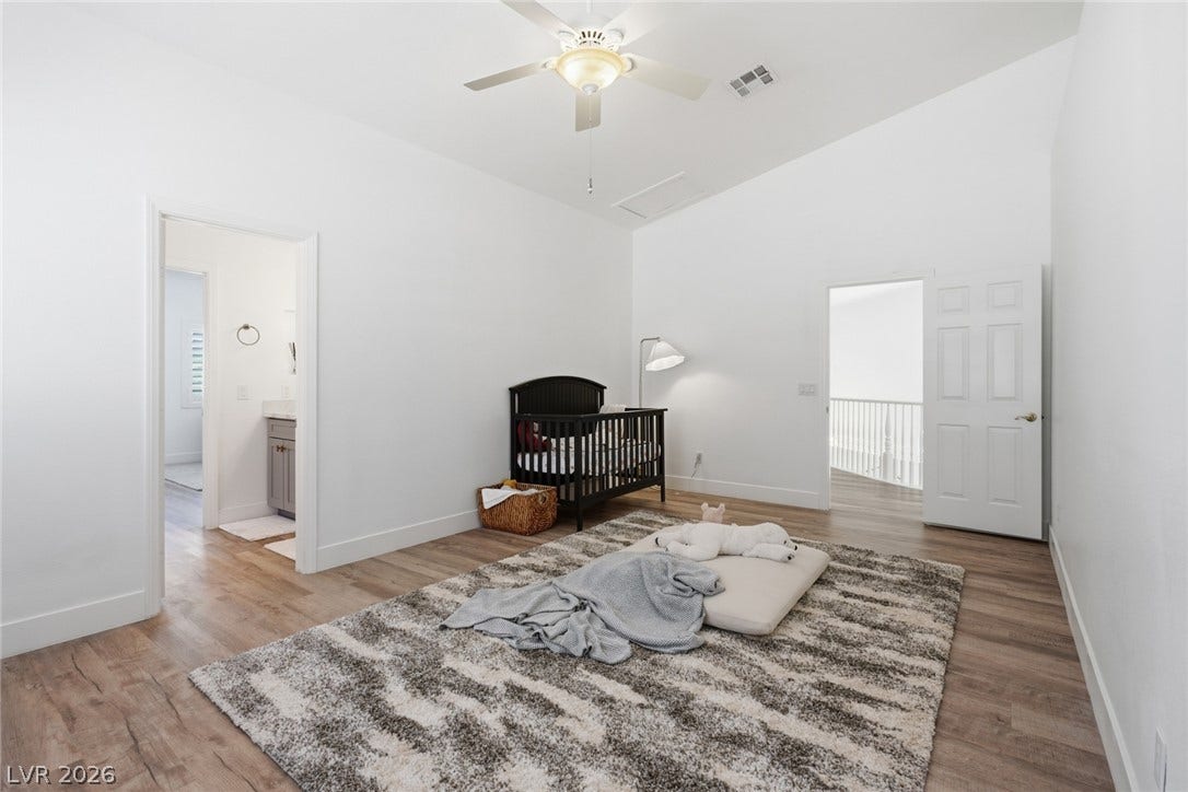 9615 Sedona Hills Court, Las Vegas, NV 89147 A tranquil primary bedroom with vaulted ceilings and a fan offers a peaceful retreat.