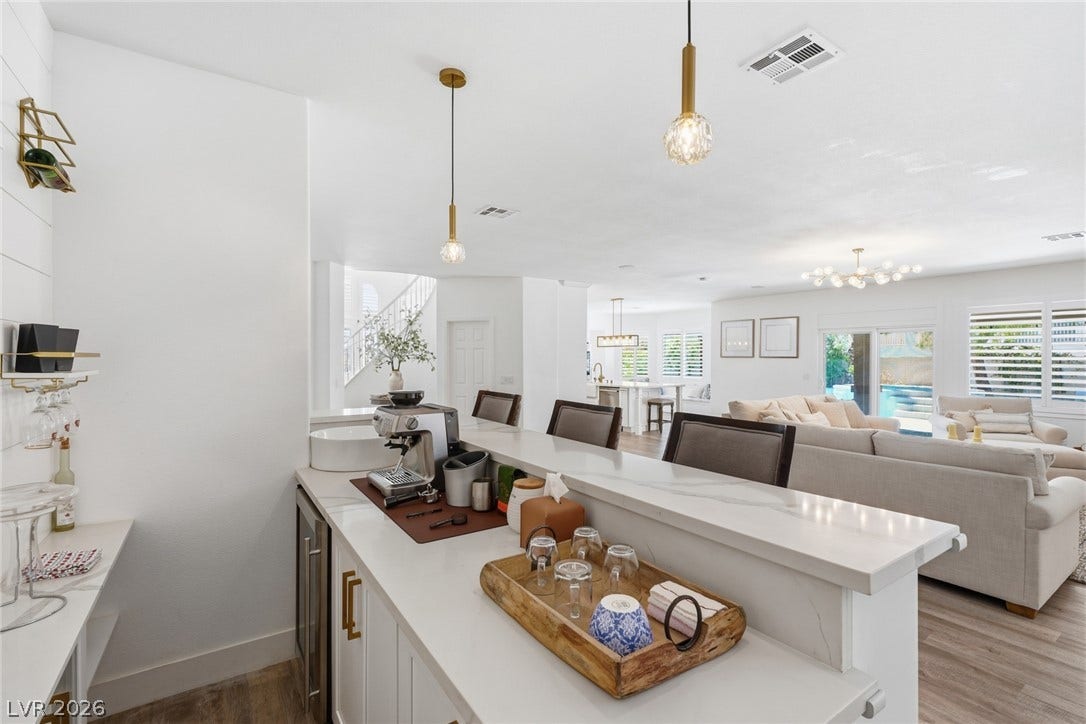 9615 Sedona Hills Court, Las Vegas, NV 89147 An inviting open-concept living space features a stylish wet bar, ideal for entertaining guests.