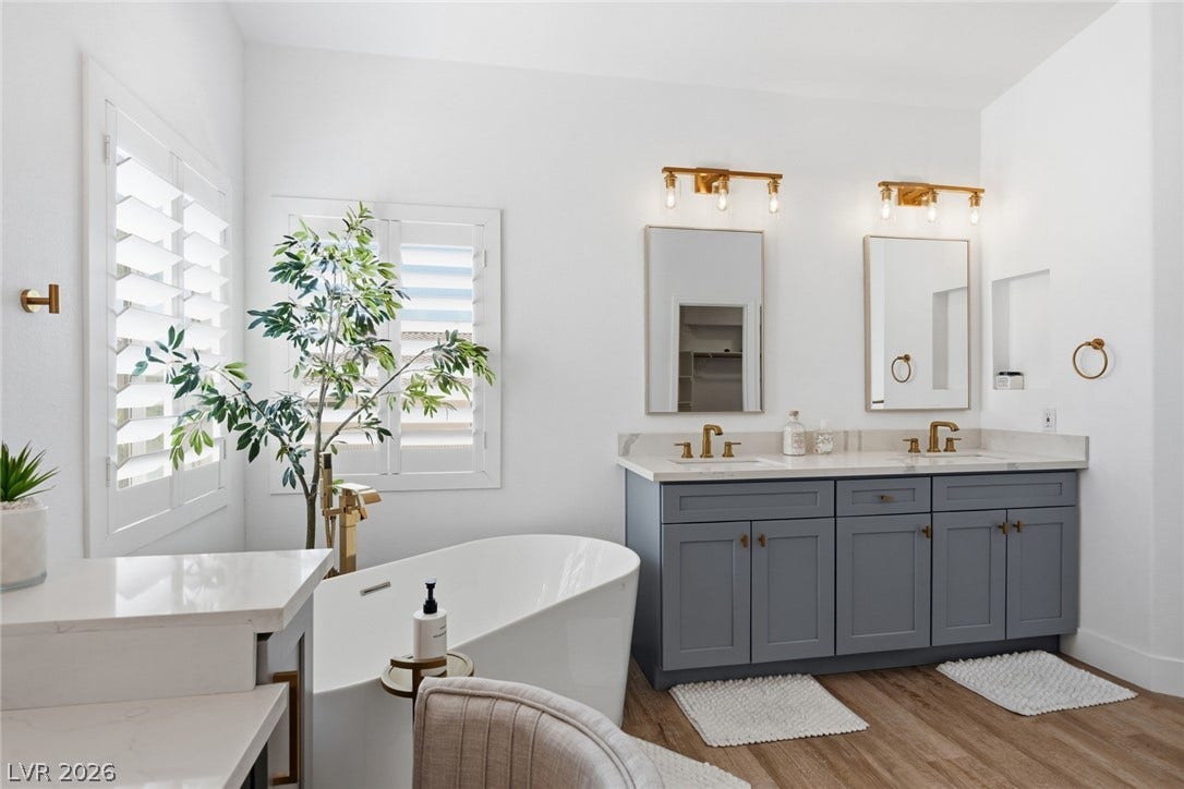 9615 Sedona Hills Court, Las Vegas, NV 89147 Indulge in a tranquil retreat featuring a deep soaking tub and stylish dual vanity.
