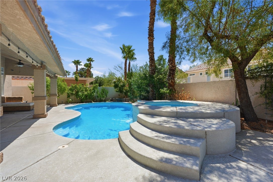 9615 Sedona Hills Court, Las Vegas, NV 89147 An inviting backyard oasis offers a free-form pool and integrated spa, perfect for relaxation and recreation.
