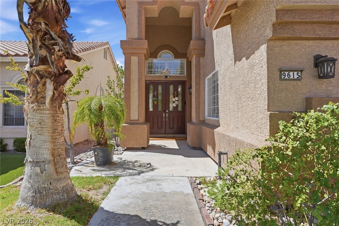9615 Sedona Hills Court, Las Vegas, NV 89147 A welcoming entry with decorative double doors opens to this desert oasis.