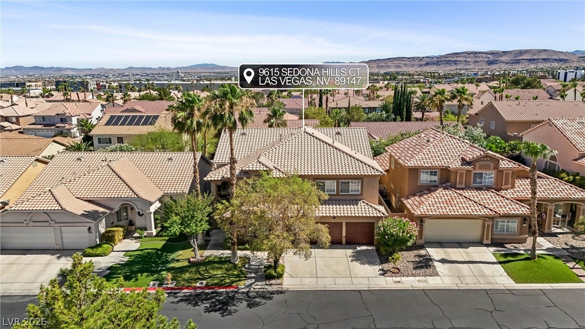 9615 Sedona Hills Court, Las Vegas, NV 89147 An aerial perspective showcases a charming residence with a tiled roof, mature landscaping, and an attached garage.