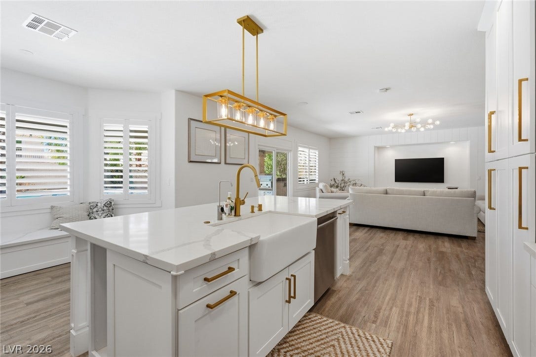 9615 Sedona Hills Court, Las Vegas, NV 89147 A seamless flow connects the bright kitchen with a generous living area, featuring an impressive island with a farmhouse sink.