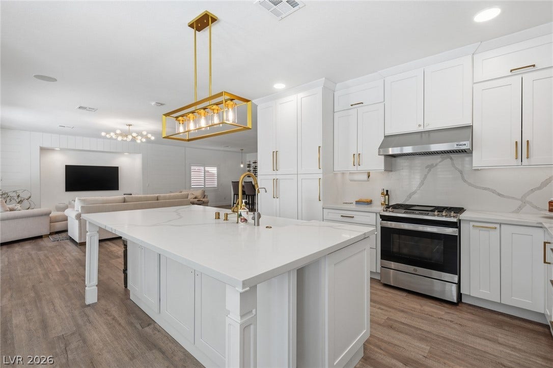 9615 Sedona Hills Court, Las Vegas, NV 89147 A well-lit, open-concept kitchen and living area showcases an oversized island and contemporary fixtures.