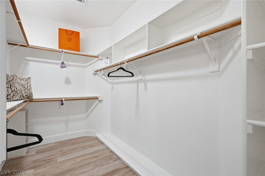 9615 Sedona Hills Court, Las Vegas, NV 89147 Functional custom closet system with ample shelving and hanging rods to organize your wardrobe.
