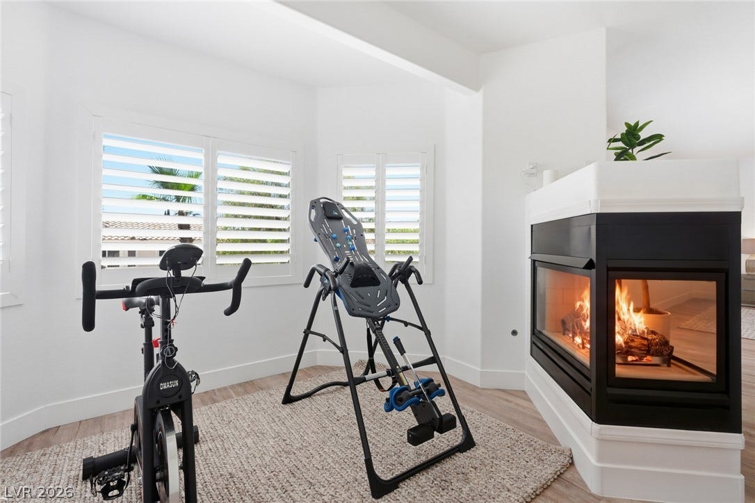 9615 Sedona Hills Court, Las Vegas, NV 89147 A corner fireplace provides a warm ambiance to this versatile exercise space.