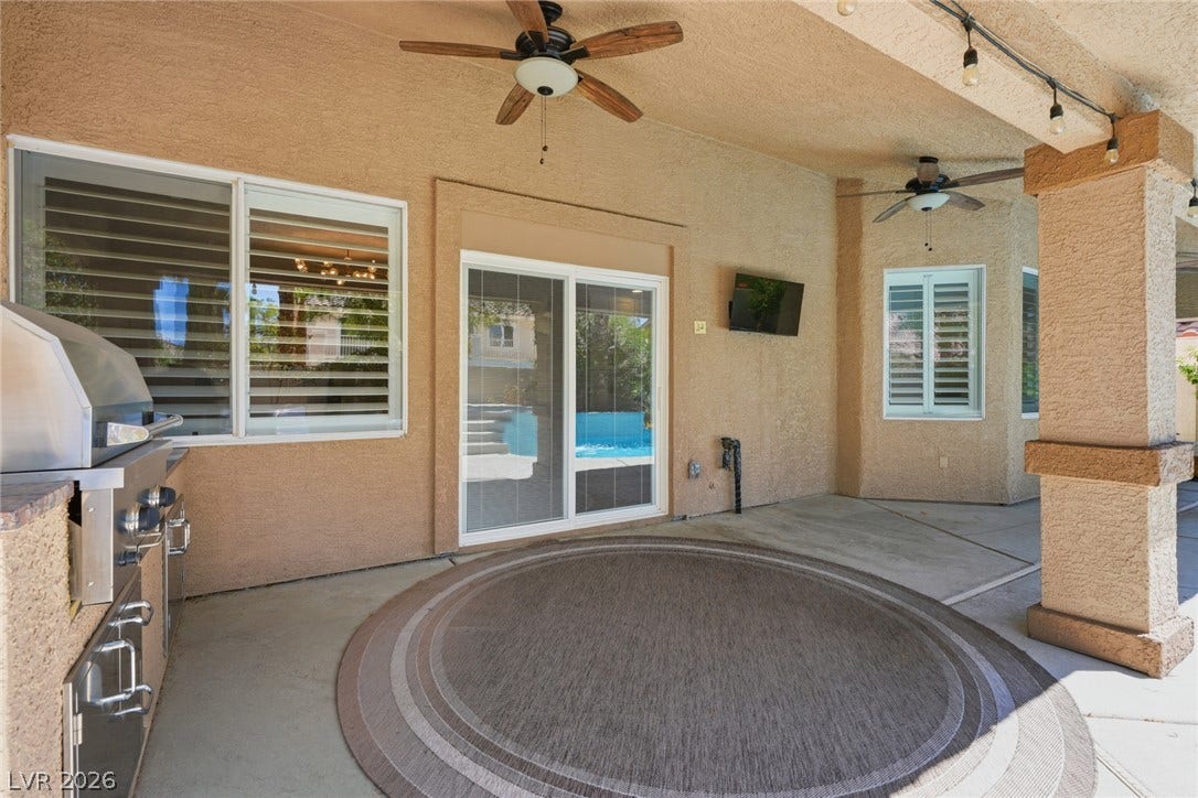 9615 Sedona Hills Court, Las Vegas, NV 89147 An inviting covered patio offers outdoor entertaining with a built-in grill and convenient access to a sparkling pool.