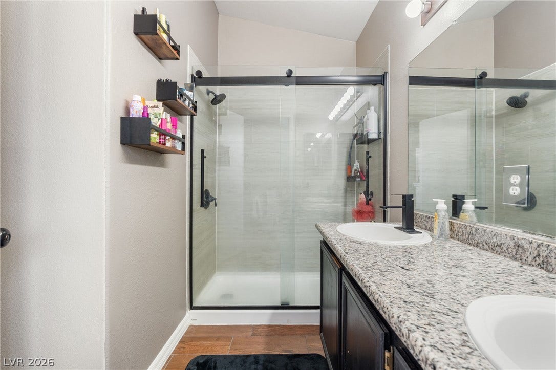 Double vanity and a spacious glass-enclosed shower create a modern and functional bathroom oasis.