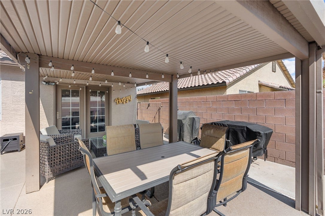 An inviting covered patio offers an ideal space for outdoor dining and relaxation.