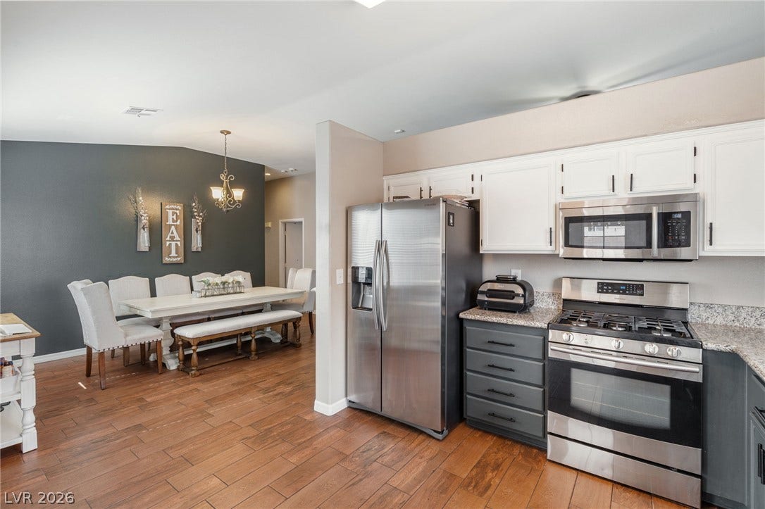 Culinary delights await in this bright kitchen with stainless steel appliances and wood-look flooring.