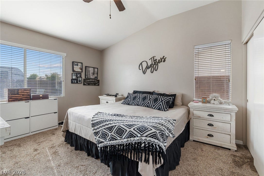 Slanted ceilings and a neutral palette offer a peaceful retreat in this cozy bedroom.