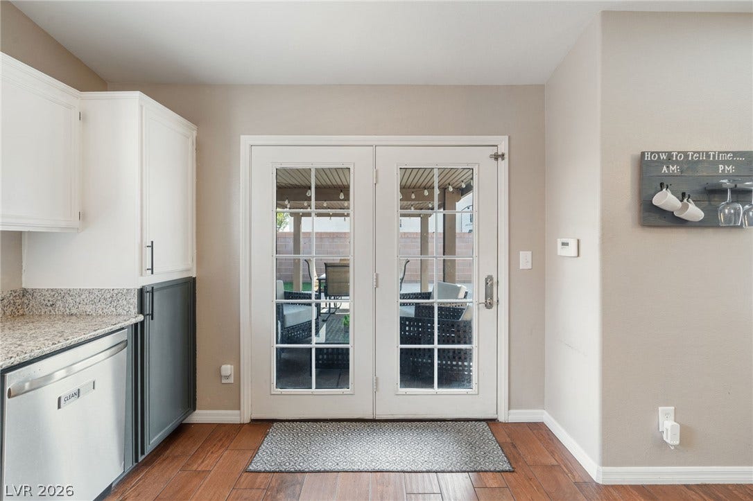 French doors open to an inviting outdoor space, expanding the living area.