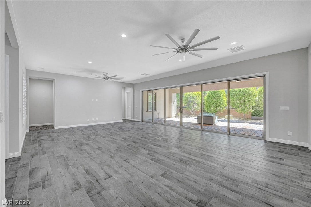 6709 Titanium Crest Street, Las Vegas, NV 89148 Sliding glass doors open to the patio from this modern living space.