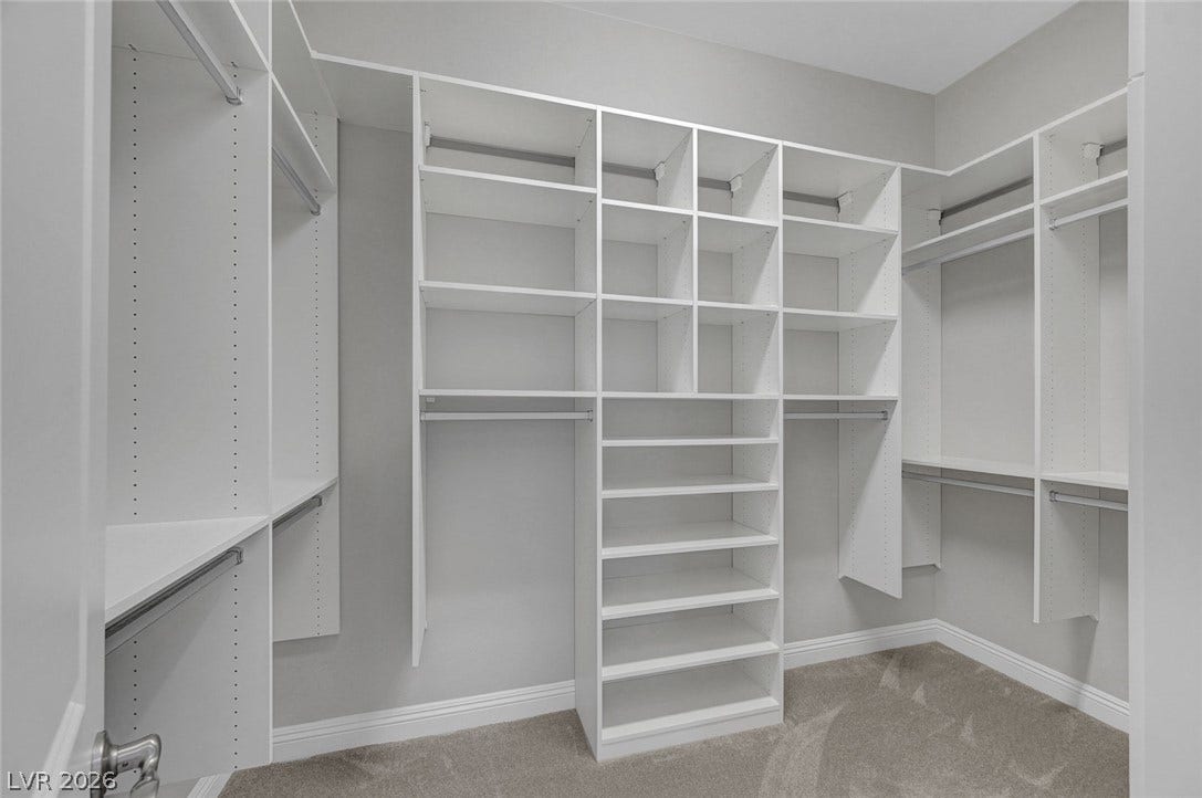 6709 Titanium Crest Street, Las Vegas, NV 89148 Custom shelving and integrated storage drawers maximize efficiency in this well-designed walk-in closet.