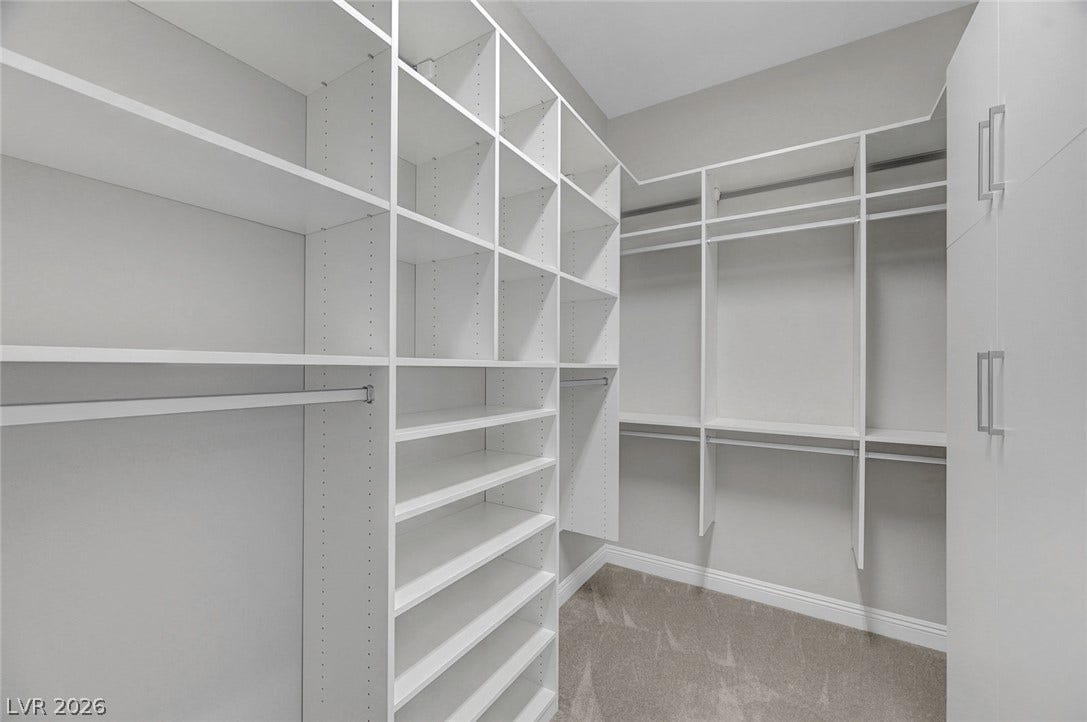 6709 Titanium Crest Street, Las Vegas, NV 89148 Custom shelving and integrated storage drawers maximize efficiency in this well-designed walk-in closet.