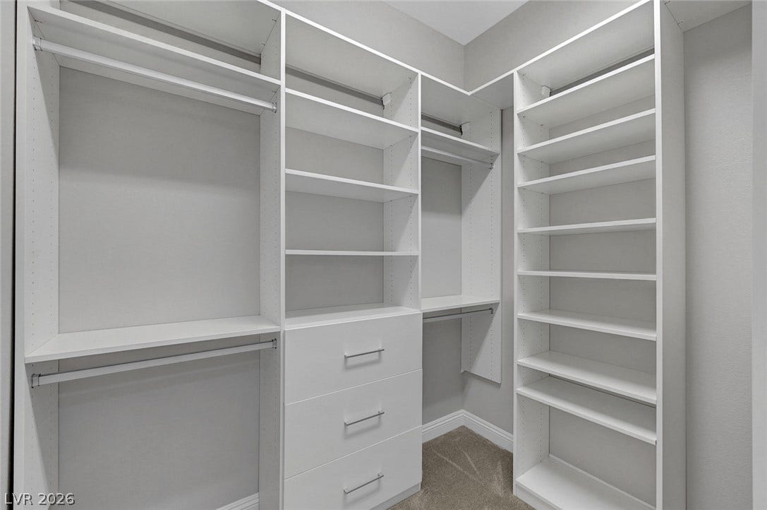 6709 Titanium Crest Street, Las Vegas, NV 89148 Custom shelving and integrated storage drawers maximize efficiency in this well-designed walk-in closet.