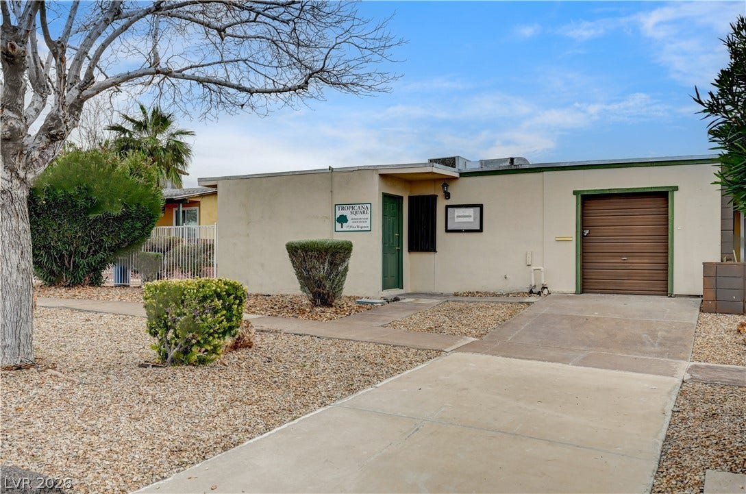 263 E Van Wagenen Street, Henderson, NV 89015 A concrete driveway leads toward the main entry and attached single-car garage.