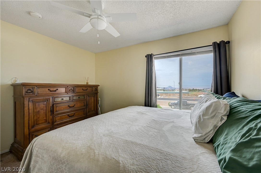 263 E Van Wagenen Street, Henderson, NV 89015 A wide window frames neighborhood views from this comfortable bedroom space.
