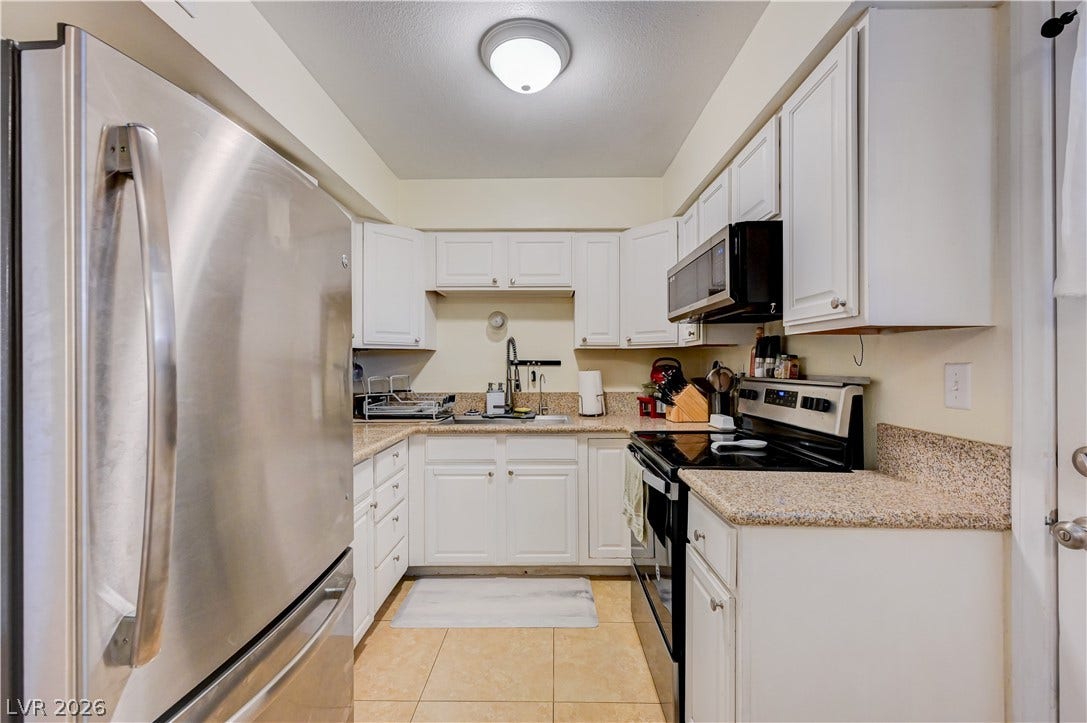 263 E Van Wagenen Street, Henderson, NV 89015 Crisp white cabinetry paired with durable countertops highlights this functional workspace.