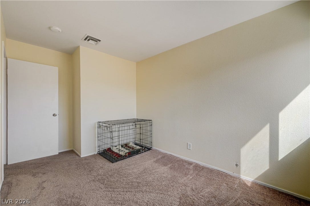 263 E Van Wagenen Street, Henderson, NV 89015 Plush wall-to-wall carpeting and soft neutral walls define this versatile secondary bedroom space.