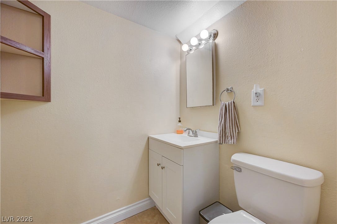 263 E Van Wagenen Street, Henderson, NV 89015 Brightly illuminated vanity area coordinates seamlessly with neutral wall finishes in this practical powder room.