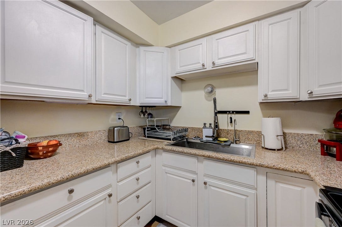 263 E Van Wagenen Street, Henderson, NV 89015 Crisp white cabinetry pairs beautifully with expansive granite countertops in this functional workspace.