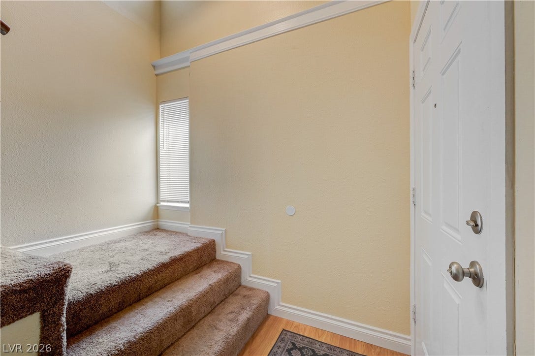 263 E Van Wagenen Street, Henderson, NV 89015 High ceilings and crisp white molding accent the carpeted split-level entry steps.