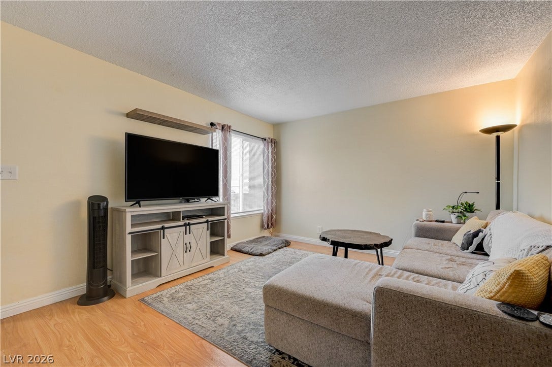 263 E Van Wagenen Street, Henderson, NV 89015 Warm wood flooring and an abundance of natural light highlight this inviting living area.