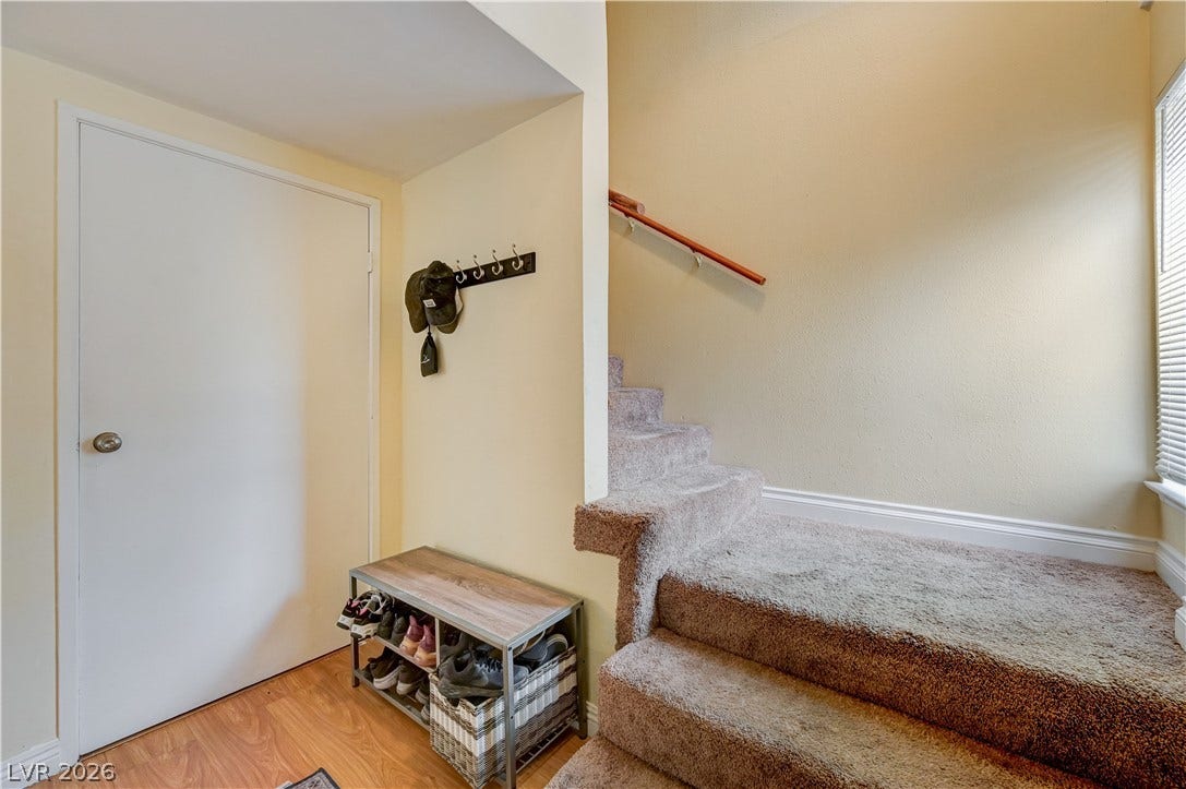 263 E Van Wagenen Street, Henderson, NV 89015 An inviting entryway transitions smoothly to carpeted stairs and warm wood-look flooring.