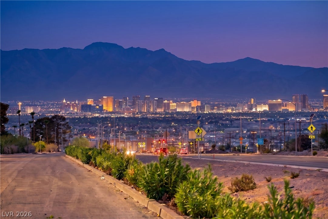 263 E Van Wagenen Street, Henderson, NV 89015 Distant mountain silhouettes frame a glittering city skyline during twilight.