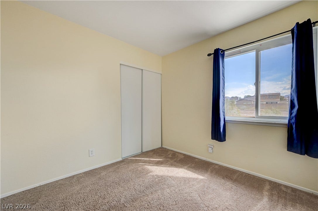 263 E Van Wagenen Street, Henderson, NV 89015 Plentiful natural light streams across carpeted flooring and classic sliding closet doors.