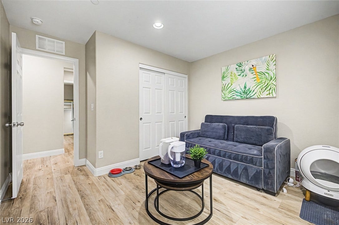 Blonde wood flooring and bright lighting create a welcoming and functional interior space.